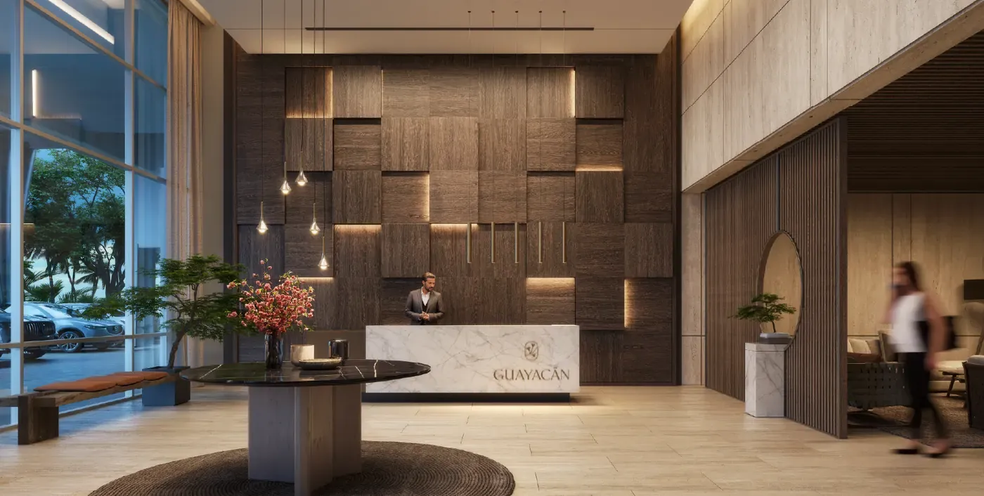 Lobby de la torre Guayacán en Santa María, con recepción y muro de madera iluminado